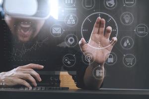 businessman wearing virtual reality goggles in modern office with mobile phone using with VR headset with screen icon diagram photo