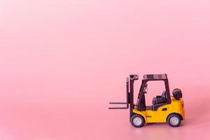 Logistics, and delivery service - Forklift model on Pink background. Shopping service on The online web and offers home delivery. photo