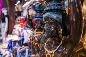 Antique statue as gift display on souvenirs stand at shop for sale photo