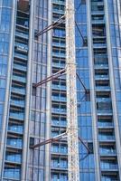 Full frame view of glass windows and balconies with beam of residential tower photo