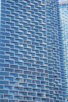 Full frame view of glass windows and balconies of residential tower photo