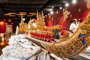 Colorful miniature boat with carved design made by wood on table photo