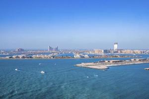 Beautiful port with city at jumeirah island against clear blue sky photo