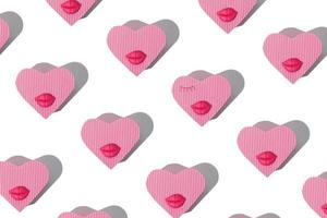 Pattern from heart shaped gift box with lips and eyelashes isolated on white photo