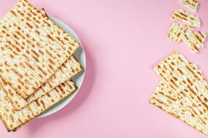 Matzo on a pink background. Traditional Jewish food  for  regilious spring holiday of Pesach. photo