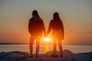 Girls hugged at sunset photo
