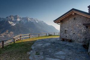 Small stone house with garden in the mountains photo