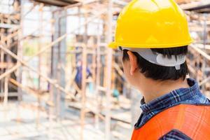 Engineer foreman checking and planning project at construction site photo