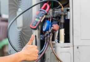 Close up of Air Conditioning Repair, repairman on the floor fixing air conditioning system photo