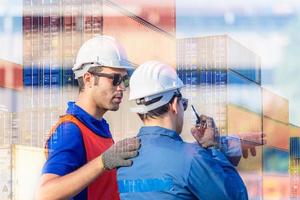 Engineer and Worker man in hardhat and safety vest checking control loading containers box from cargo, Teamwork concept photo