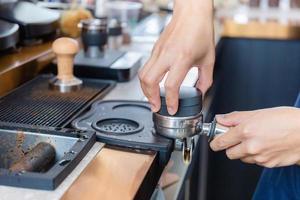 Close up of Barista hand making coffee on the machine photo