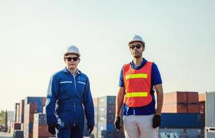 Cheerful factory engineer and worker man in hard hat smiling and looking at sky with joy, Happiness concept photo