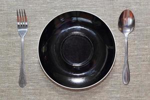 empty plate with spoon and fork photo