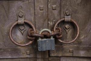 Steel padlock keeping the old door