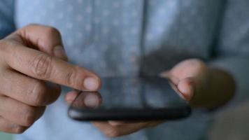 Nahaufnahme Finger einer Frau, die den Touchscreen des mobilen Smartphones scrollt, während sie soziale Medien online anschaut.