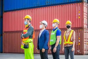 protection face mask against coronavirus, Business people team standing in line at cargo containers photo