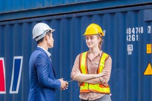 Engineer and foreman worker team checking containers box from cargo, Logistic and teamwork concept photo