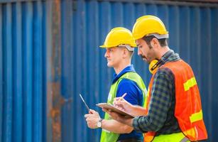 Engineer and worker team checking containers box from cargo with blurred background, Teamwork concept photo