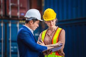 Engineer and worker team checking containers box from cargo, Logistic and teamwork concept photo