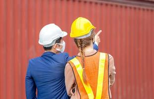 Engineer and worker team checking containers box from cargo, Logistic and teamwork concept photo