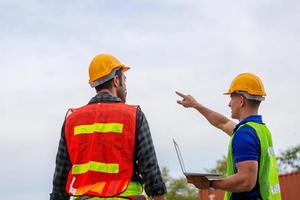 Engineer and factory worker team checking containers box from cargo with blurred background, Teamwork concept photo