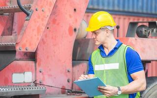 Professional technician pre-check forklift truck at container cargo, safety concept photo