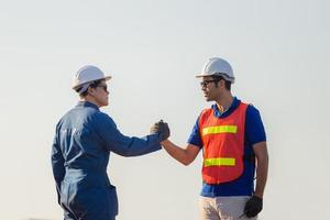 Engineer and worker soul brother handshake, thumb clasp handshake or homie handshake, Happy foreman team join hands together, Success and Teamwork concepts photo