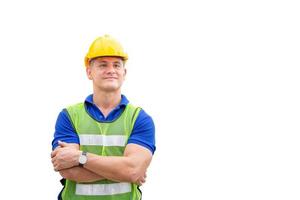 Cheerful engineer man in hard hat with clipping path with arms crossed on white background photo