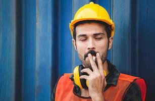 Factory worker with a cigarette smoke break, Labour takes a cigarette break photo