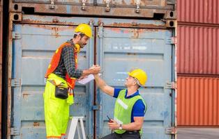 Engineer and worker soul brother handshake, thumb clasp handshake or homie handshake with blurred containers cargo background, Success and Teamwork concept photo