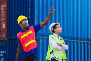 Female engineer and worker man with clipping path checking containers box from cargo photo