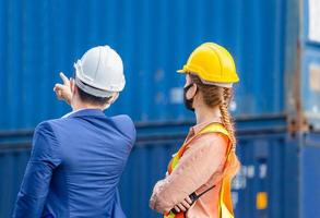 Engineer and worker team checking containers box from cargo, Logistic and teamwork concept photo