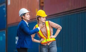 Engineer and foreman worker team checking containers box from cargo, Logistic and teamwork concept photo