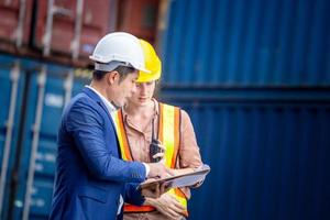 Engineer and worker team checking containers box from cargo, Logistic and teamwork concept photo