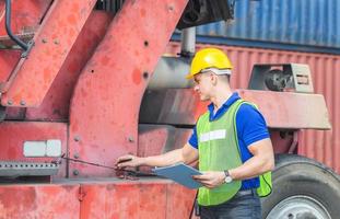 Professional technician pre-check forklift truck at container cargo, safety concept photo