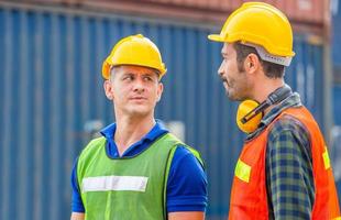 Engineer and factory worker team checking containers box from cargo with blurred background, Teamwork concept photo