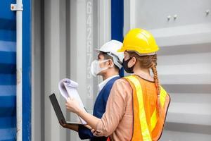 Engineer and foreman worker team checking containers box from cargo, Logistic and teamwork concept photo