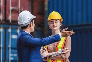 Engineer and worker team checking containers box from cargo, Logistic and teamwork concept photo