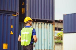 Factory worker man checking containers box from cargo photo