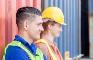 Cheerful factory worker relax take a break at cargo containers, Happiness working concept photo