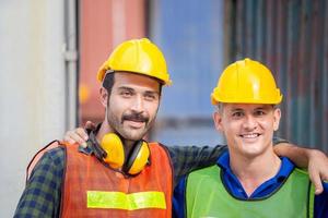 Happiness and smiling engineer and worker man standing with hands on shoulders and looking at camera photo