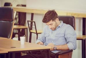 Casual man use mobile smartphone checks social network while take a break photo