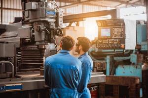 ingeniería industrial con control uniforme de seguridad que opera la máquina rectificadora de torno que trabaja en la fábrica de la industria. foto