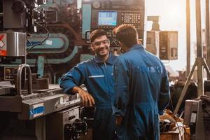 Industry engineering wearing safety uniform control operating lathe grinding machine working in industry factory. photo