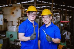 Industry engineering wearing safety uniform control operating computer controlled lathe grinding machine working in industry factory. photo