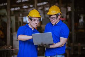 Industry engineering wearing safety uniform control operating computer controlled lathe grinding machine working in industry factory. photo