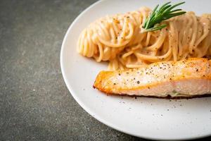 grilled salmon with spaghetti creamy tomato sauce photo