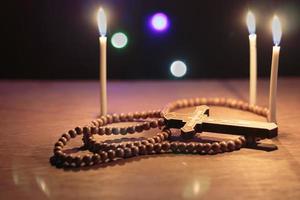 crucifix with rosary on wooden floor photo