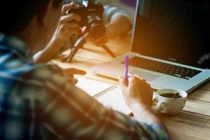 Writing on paper at work on the table in the morning, business ideas. There is space for copying. photo