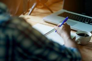 Writing on paper at work on the table in the morning, business ideas. There is space for copying. photo